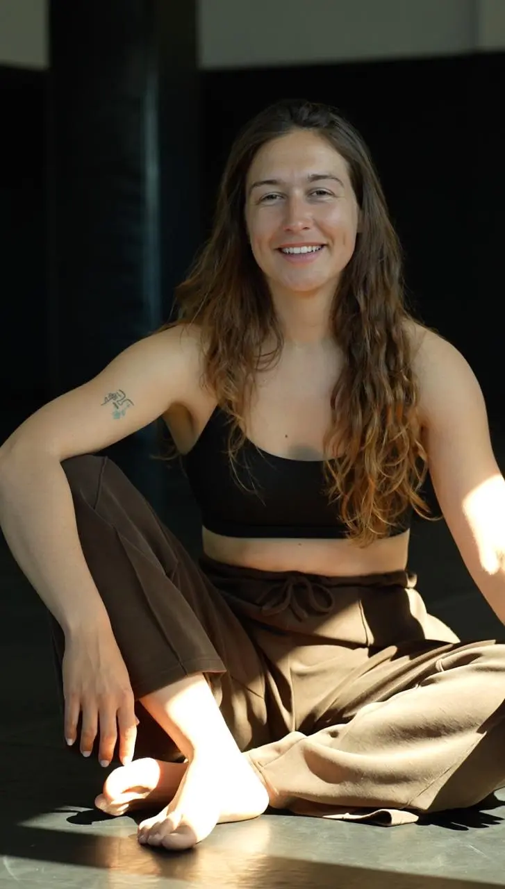 Emma, recovery and mental preparation coach, seated and smiling